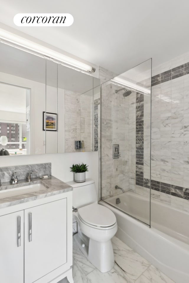 bathroom with toilet, shower / bath combination with glass door, marble finish floor, and vanity