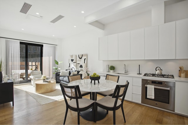 dining space featuring light wood-style floors, recessed lighting, and visible vents