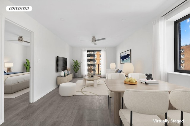 dining area featuring baseboards, wood finished floors, visible vents, and ceiling fan