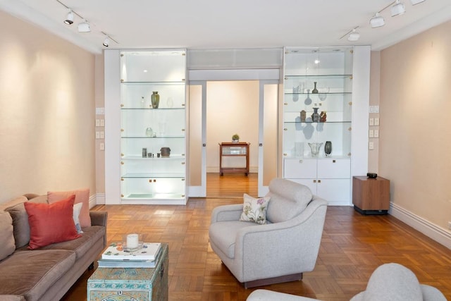 interior space with an inviting chandelier, radiator, crown molding, and parquet flooring