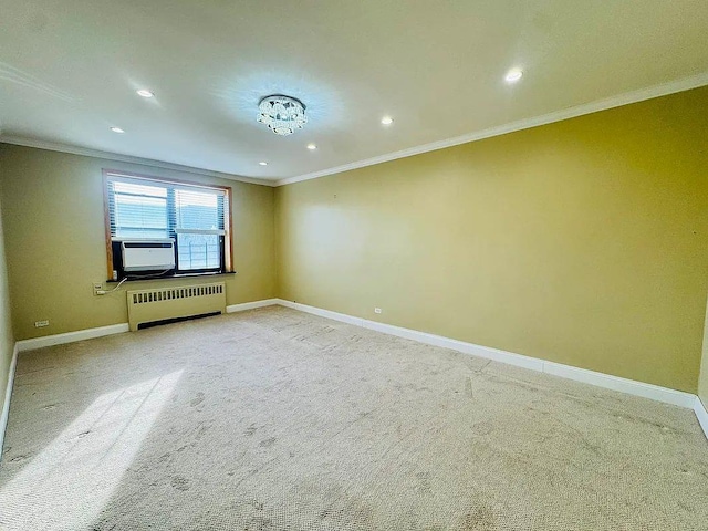 empty room with radiator, baseboards, recessed lighting, light carpet, and crown molding