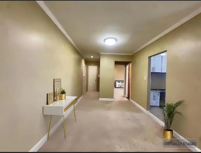 hallway with carpet, baseboards, and ornamental molding