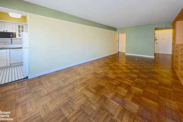 unfurnished room with baseboards