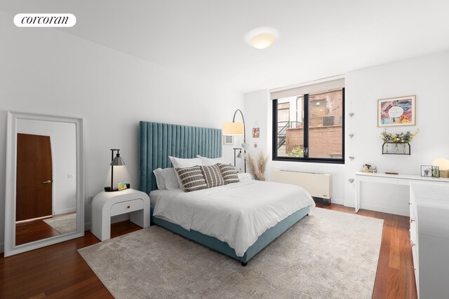 50 W 15th St Unit 2E, New York City, NY 10011 - bedroom with radiator heating unit and wood finished floors