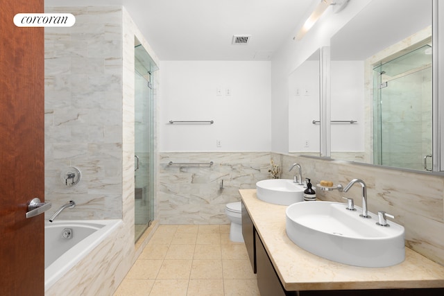 50 W 15th St Unit 2E, New York City, NY 10011 - full bathroom featuring a stall shower, tile walls, a tub, double vanity, and toilet