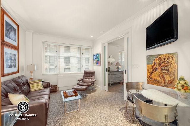 living area featuring healthy amount of natural light, carpet, and crown molding