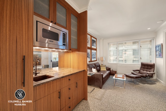 living area with ornamental molding and carpet floors