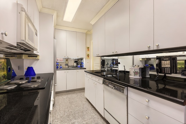 475 Park Ave Unit 8A/Sr23, New York City, NY 10022 - kitchen with white appliances, dark countertops, white cabinets, and dark aggregate flooring