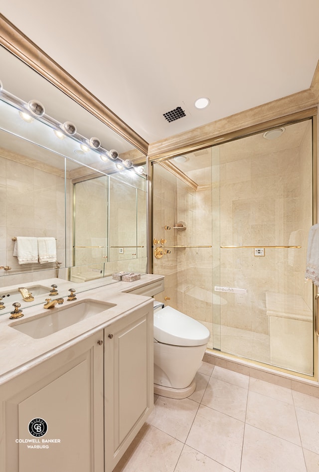bathroom featuring tile patterned flooring, a stall shower, vanity, and toilet