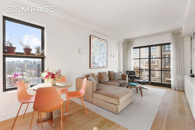 living room featuring light wood-type flooring and baseboards