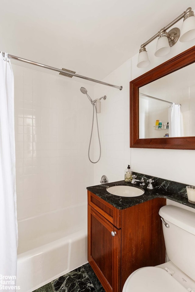 full bathroom with marble finish floor, vanity, shower / bath combo with shower curtain, and toilet