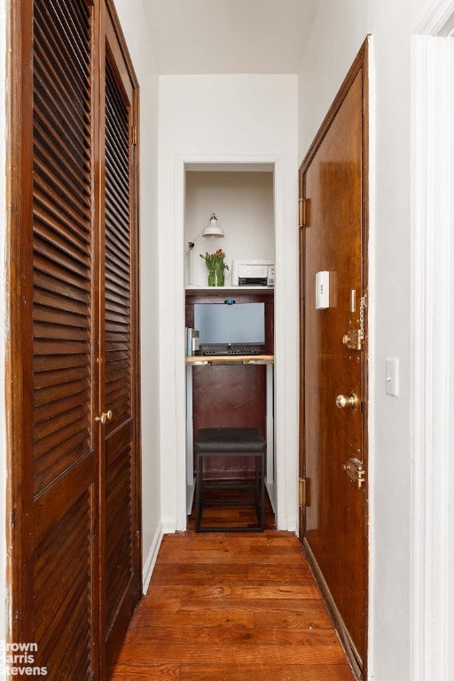 hall with dark hardwood / wood-style floors