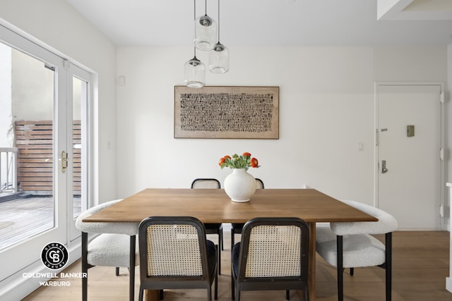 dining area featuring light wood-type flooring and french doors