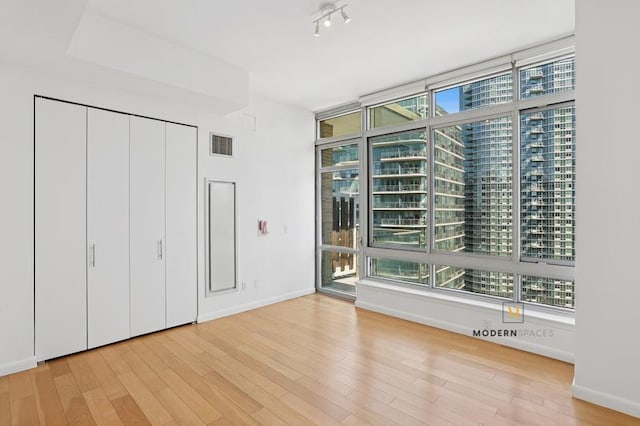 46-30 Center Blvd Unit Ph-3, New York City, NY 11109 - unfurnished bedroom with wood finished floors, multiple windows, and access to exterior