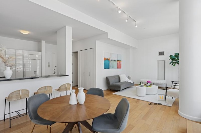 46-30 Center Blvd Unit Ph-3, New York City, NY 11109 - dining area featuring rail lighting and wood finished floors