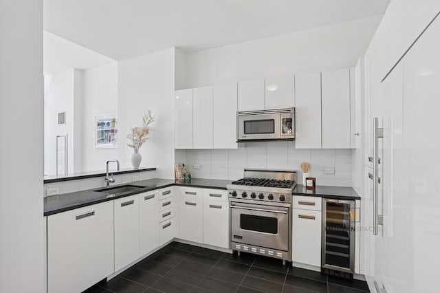 46-30 Center Blvd Unit Ph-3, New York City, NY 11109 - kitchen featuring wine cooler, stainless steel appliances, dark countertops, dark tile patterned floors, and tasteful backsplash