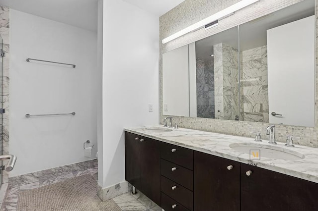 46-30 Center Blvd Unit Ph-3, New York City, NY 11109 - full bathroom with a marble finish shower, marble look tile flooring, double vanity, and decorative backsplash