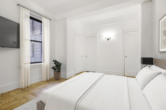 bedroom with baseboards and refrigerator