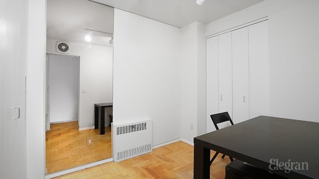 home office with radiator and parquet flooring