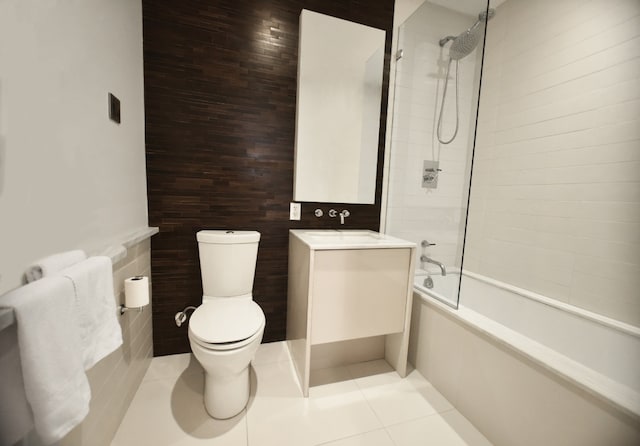 full bathroom featuring vanity, tiled shower / bath, tile patterned floors, and toilet