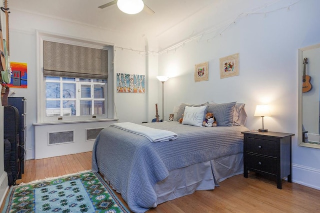 bedroom with hardwood / wood-style flooring and ceiling fan