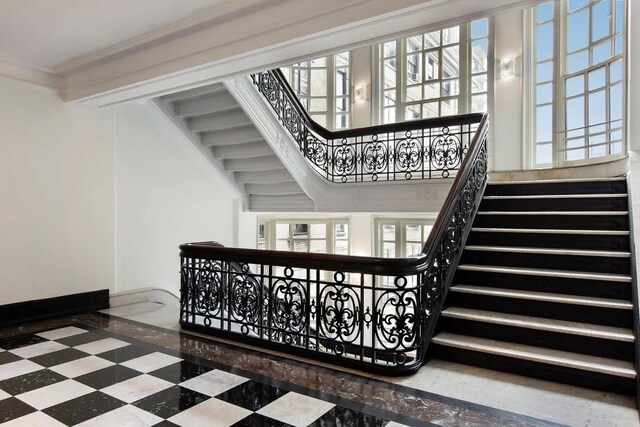 2109 Broadway Unit 902, New York City, NY 10023 - staircase featuring inlaid floor details and crown molding