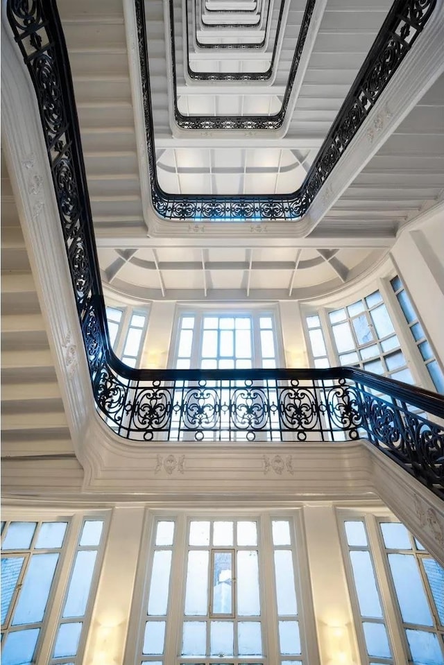 2109 Broadway Unit 902, New York City, NY 10023 - stairway featuring a towering ceiling, coffered ceiling, and beam ceiling