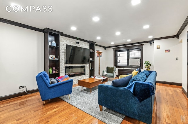 living area with a stone fireplace, crown molding, light wood-type flooring, baseboards, and recessed lighting
