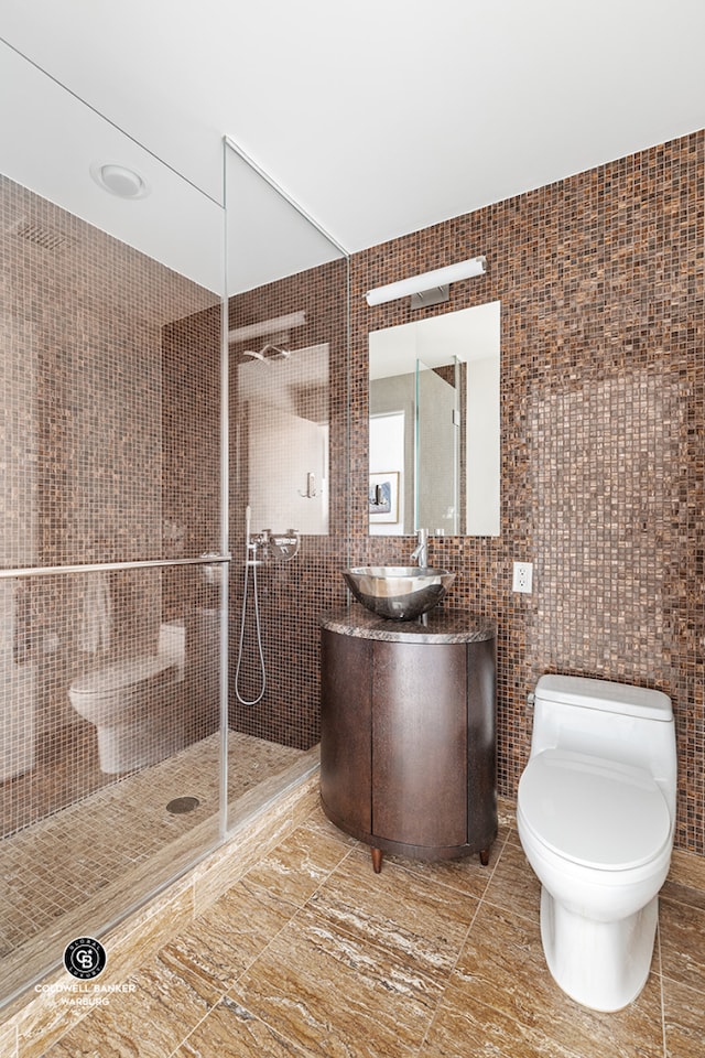 250 E 53rd St Unit 3004, New York City, NY 10022 - bathroom featuring tile walls, toilet, a shower stall, and vanity