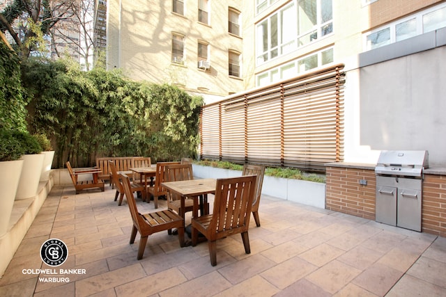 250 E 53rd St Unit 3004, New York City, NY 10022 - view of patio featuring outdoor dining space and an outdoor kitchen