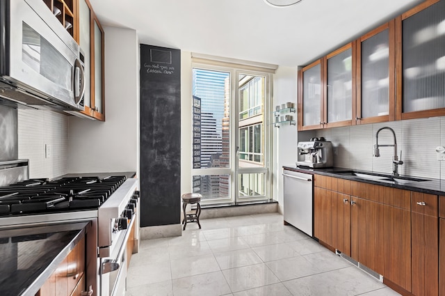 250 E 53rd St Unit 3004, New York City, NY 10022 - kitchen featuring stainless steel appliances, tasteful backsplash, brown cabinets, glass insert cabinets, and light tile patterned floors