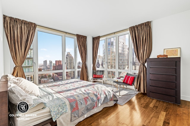 250 E 53rd St Unit 3004, New York City, NY 10022 - bedroom with a skyline view and wood finished floors