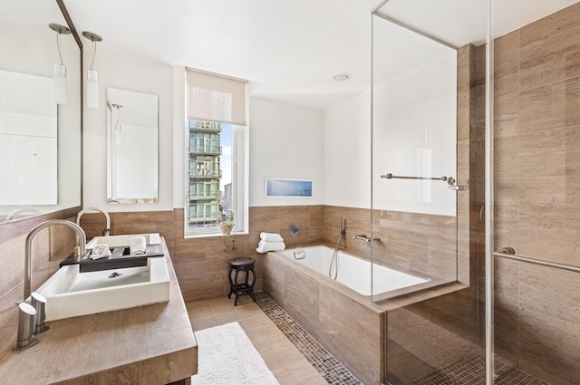 250 E 53rd St Unit 3004, New York City, NY 10022 - bathroom with a garden tub, double vanity, tile walls, a stall shower, and a wainscoted wall