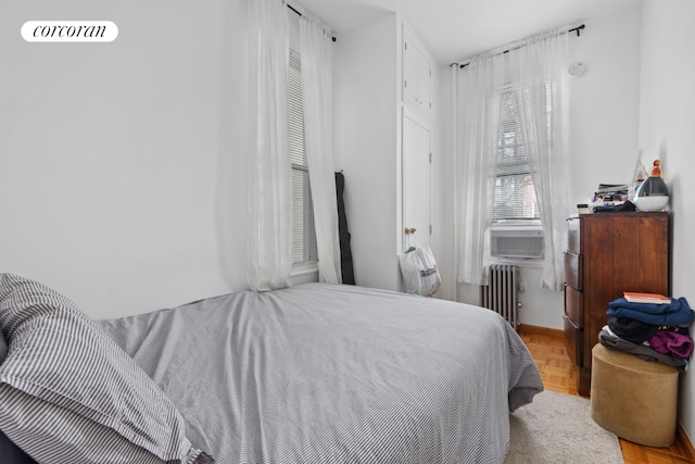 bedroom featuring cooling unit and radiator heating unit