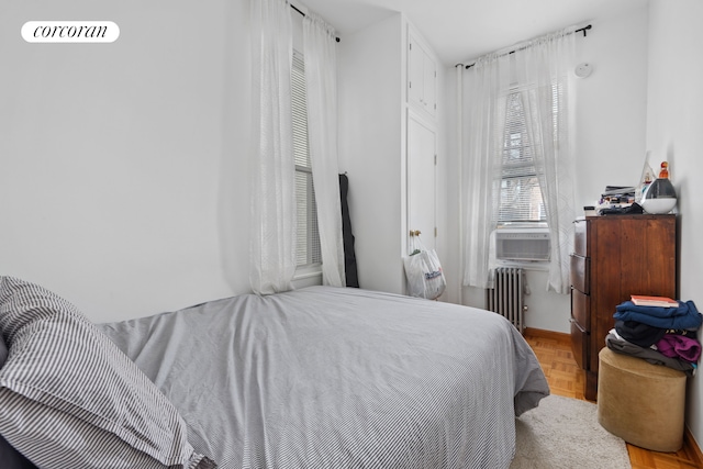 bedroom with radiator heating unit and cooling unit