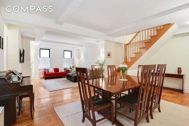 dining area with stairs, beamed ceiling, and baseboards