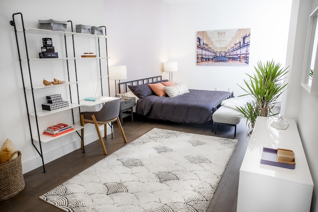bedroom featuring baseboards and wood finished floors