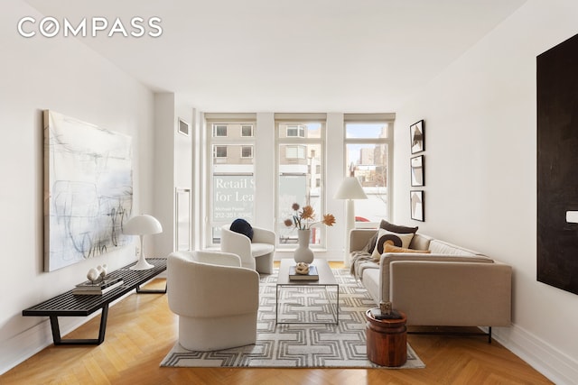 living area featuring visible vents and baseboards