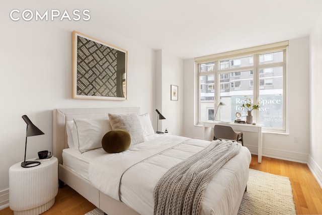 bedroom featuring baseboards and wood finished floors