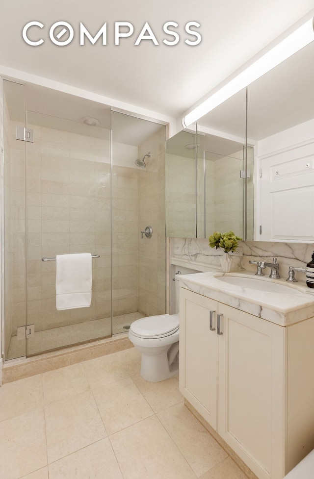 full bath with toilet, tile patterned floors, a shower stall, and vanity