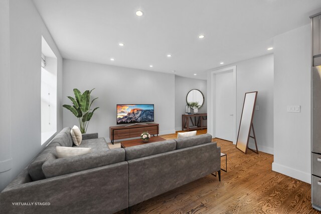 kitchen featuring stacked washer / dryer, gray cabinetry, stainless steel appliances, and radiator heating unit