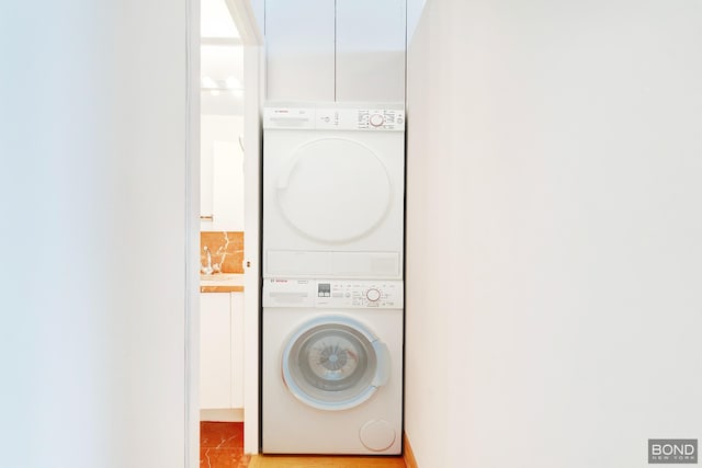 laundry area featuring stacked washer and dryer and laundry area