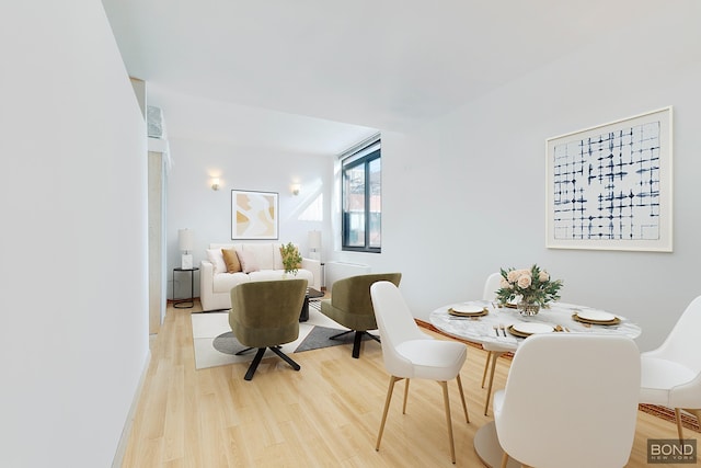 dining space featuring light wood-style flooring