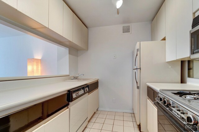 kitchen with a sink, visible vents, white cabinets, dishwasher, and gas range