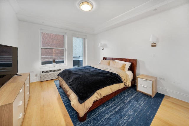 bedroom featuring ornamental molding, a wall mounted air conditioner, and dark hardwood / wood-style flooring