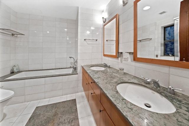 full bathroom featuring tile patterned floors, toilet, tasteful backsplash, tile walls, and vanity