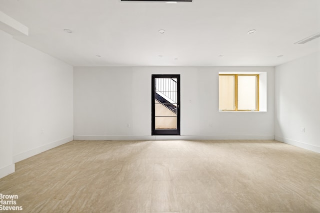 unfurnished room featuring recessed lighting, visible vents, and baseboards