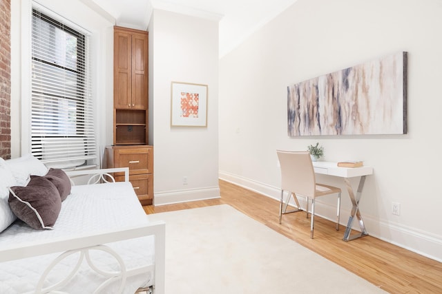 bedroom featuring baseboards and light wood-style floors