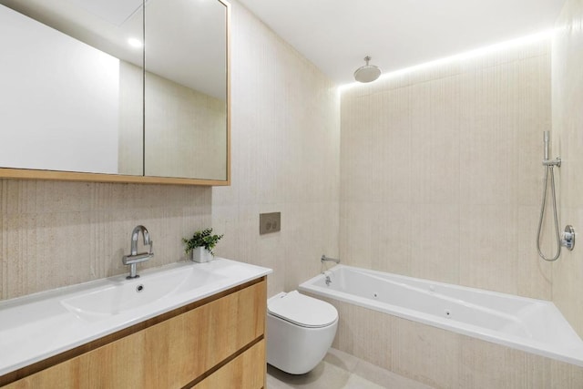 full bathroom featuring toilet, tile walls, vanity, and tiled shower / bath