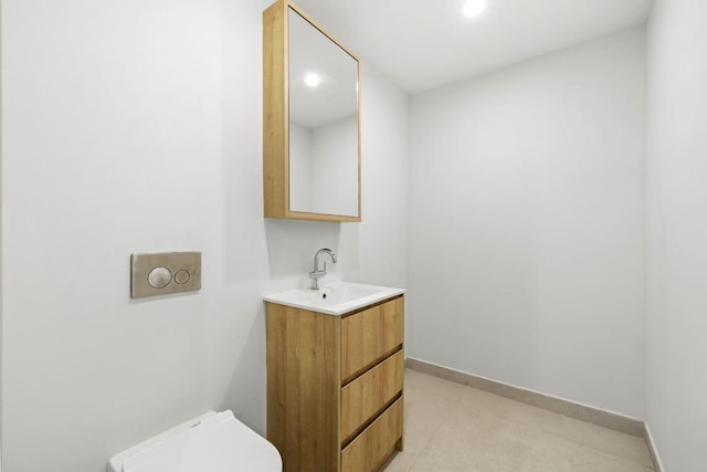 bathroom featuring vanity and toilet